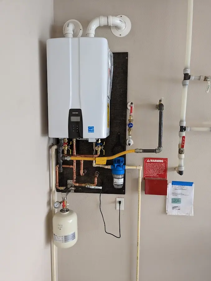 Professional plumber installing copper piping in a Haleyville home